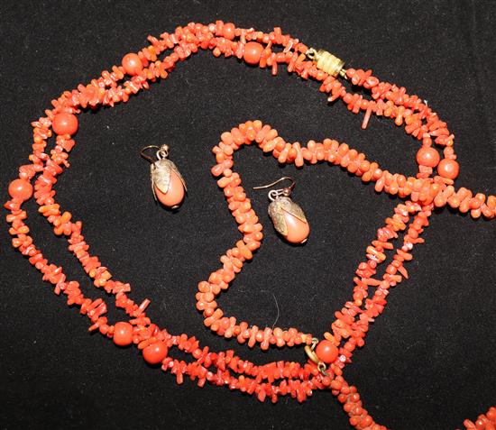 A coral necklace, bracelet and earrings.